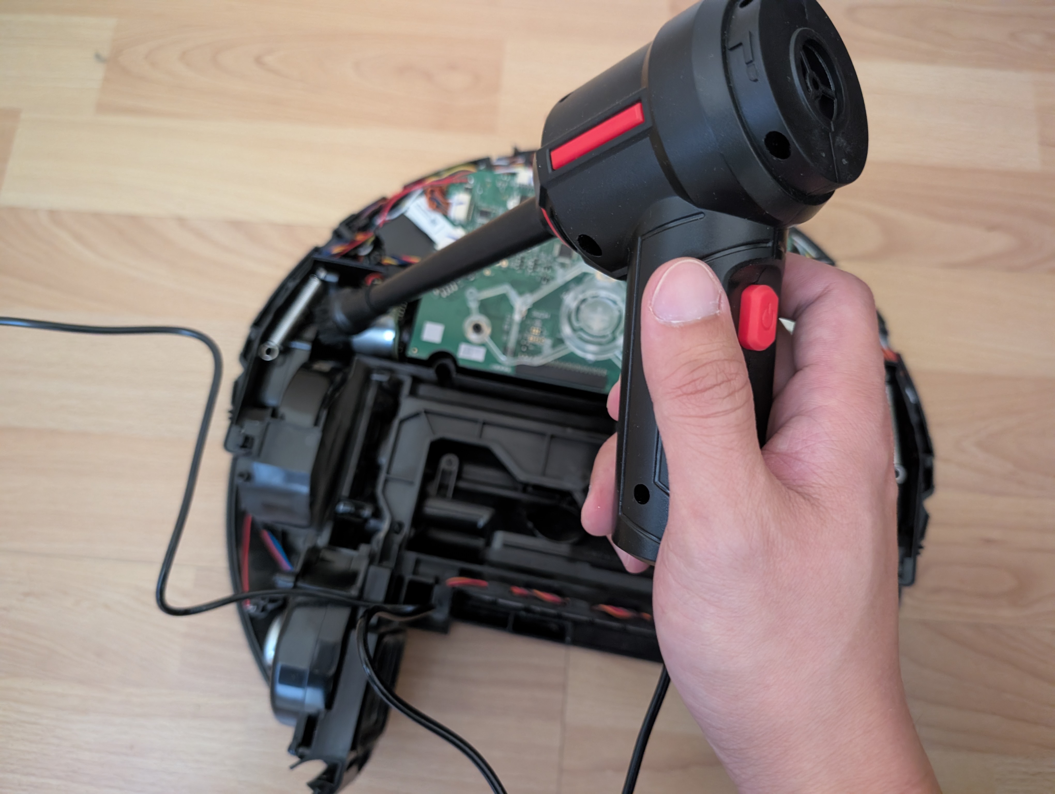 Close-up of the blower nozzle working around the main board connectors