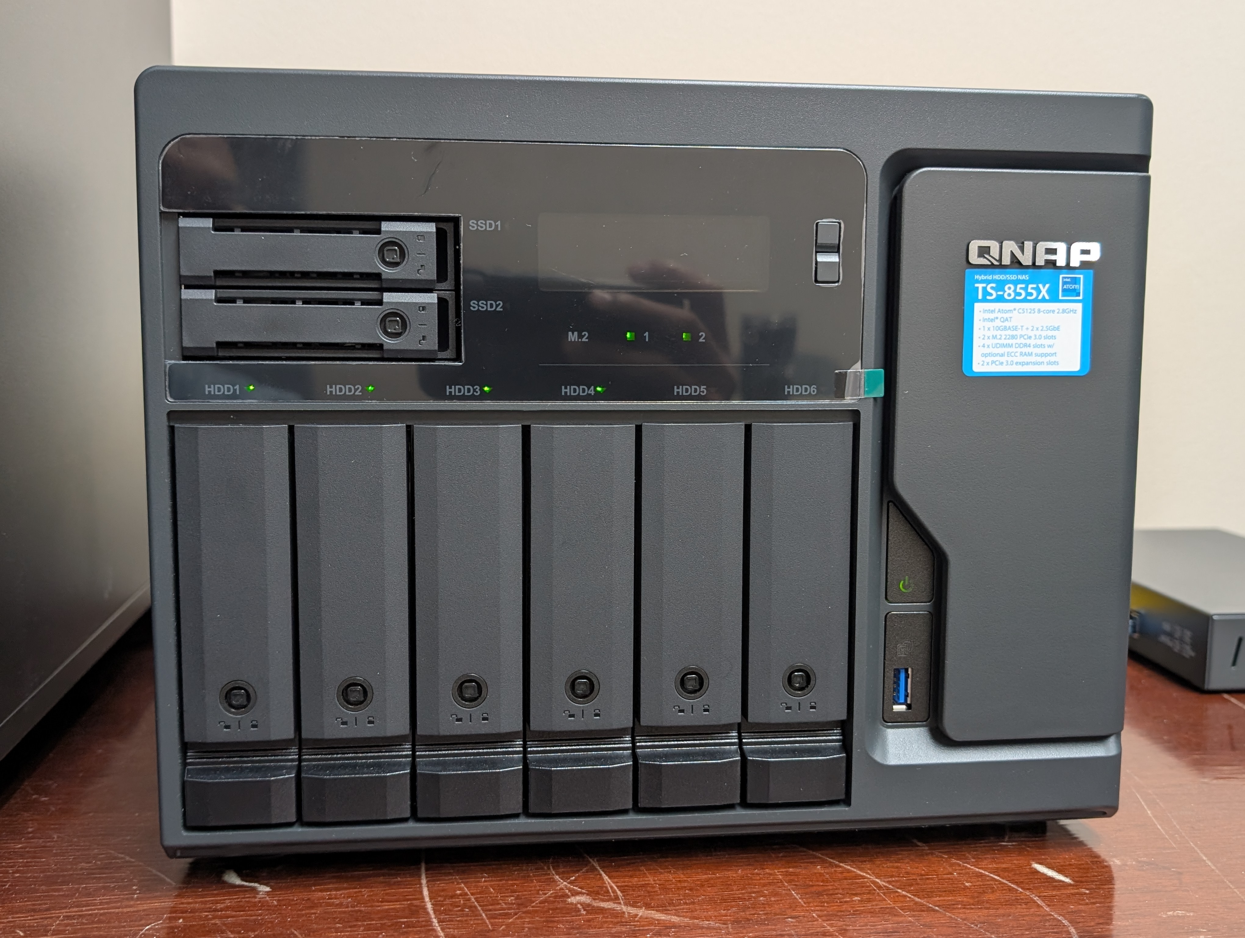 Both M.2 indicator lights illuminated on the QNAP TS-855X front panel, confirming both NVMe drives are detected
