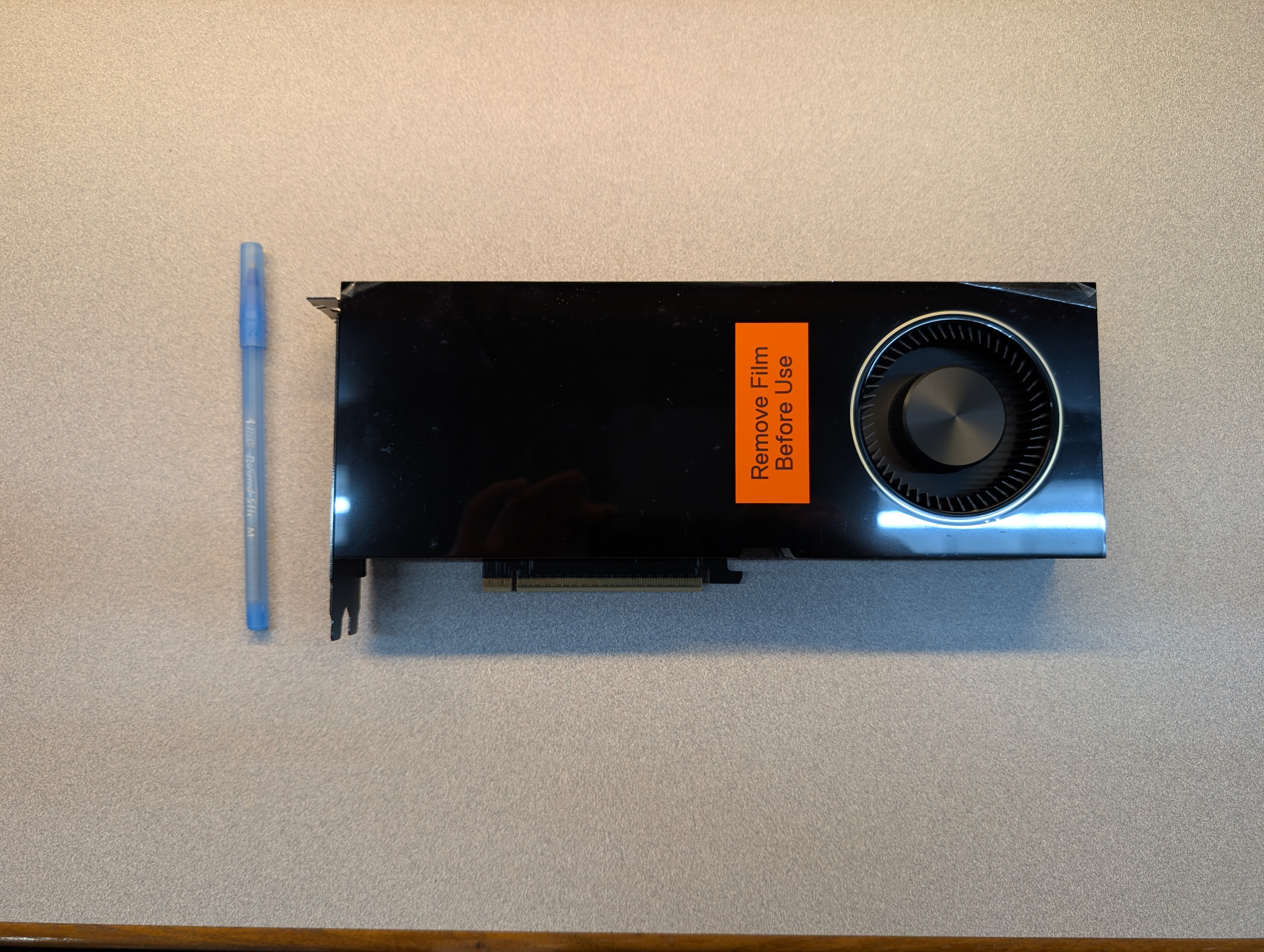 The new RTX PRO 6000 Blackwell card next to a pen for scale